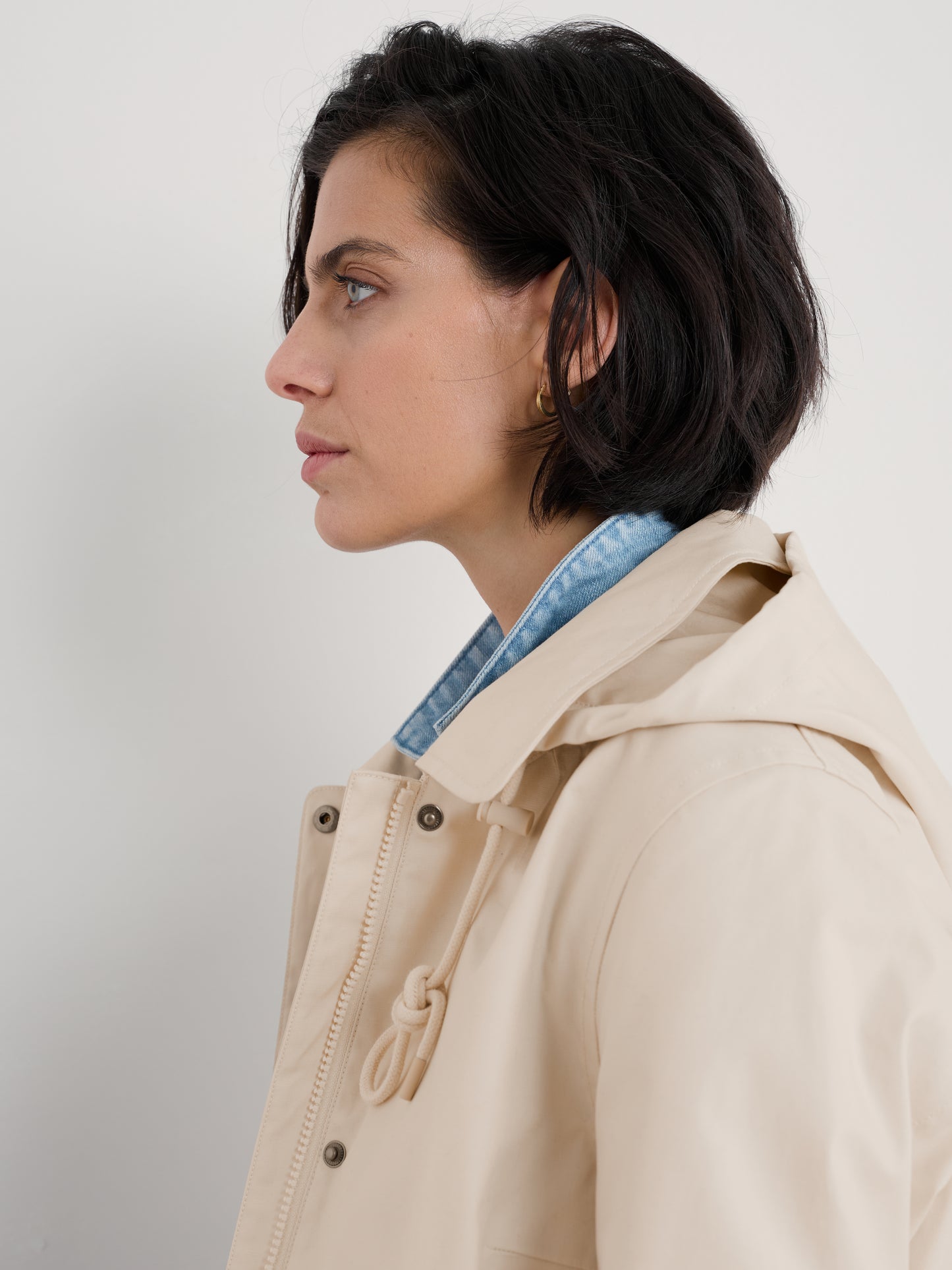 Woman wearing The Cloudburst Rainproof Mac in Limestone by SEASALT for women