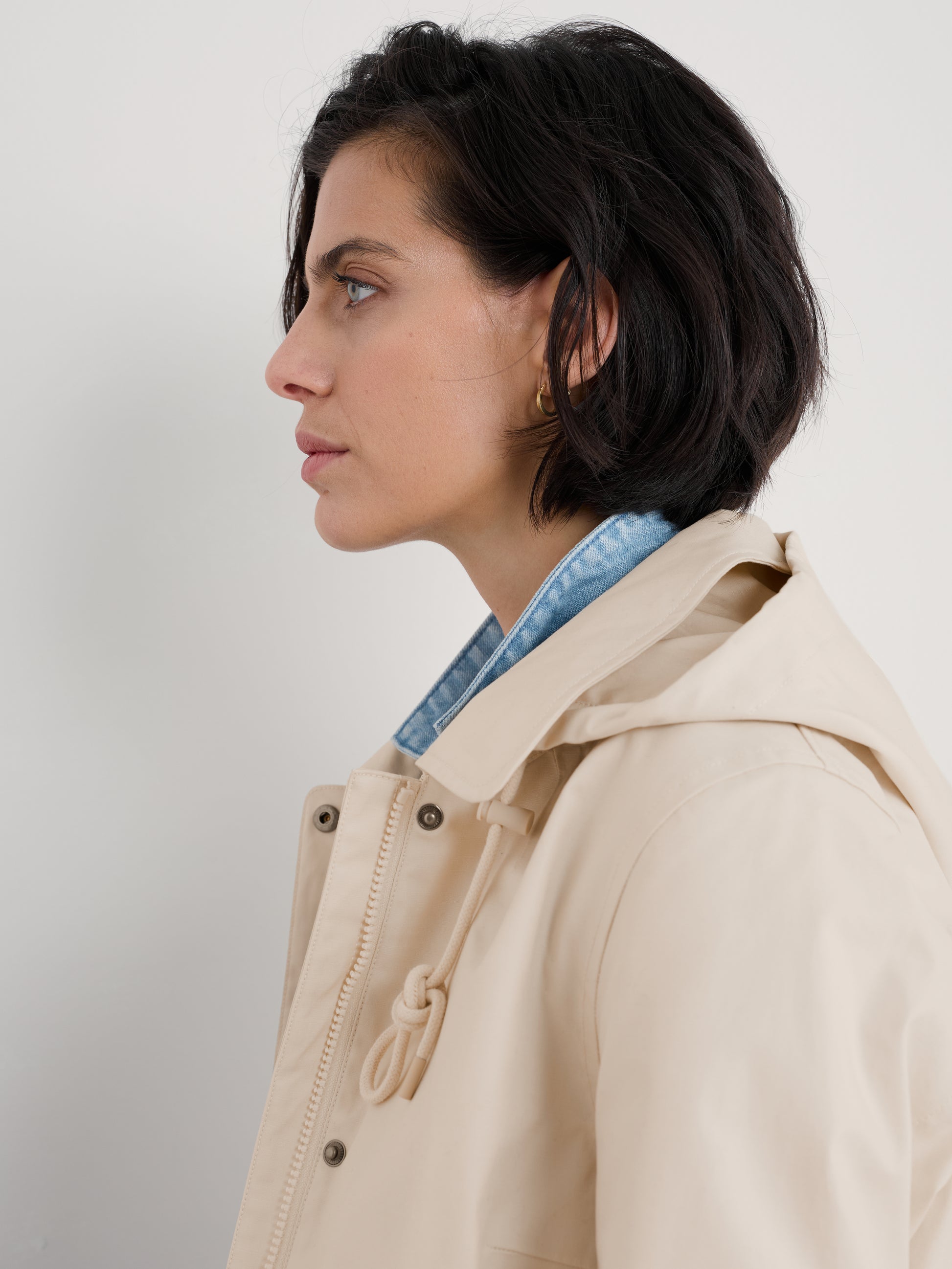 Woman wearing The Cloudburst Rainproof Mac in Limestone by SEASALT for women