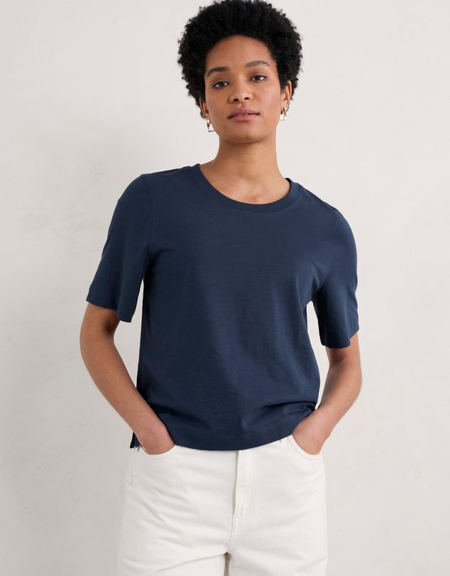 Woman wearing the cotton Copseland Tee by SEASALT in Maritime navy