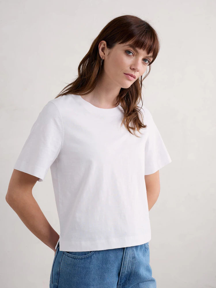 Woman wearing the cotton Copseland white T-Shirt by SEASALT in Salt