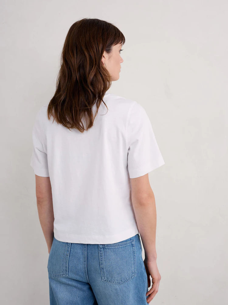 Woman wearing the cotton Copseland white Tee by SEASALT in Salt