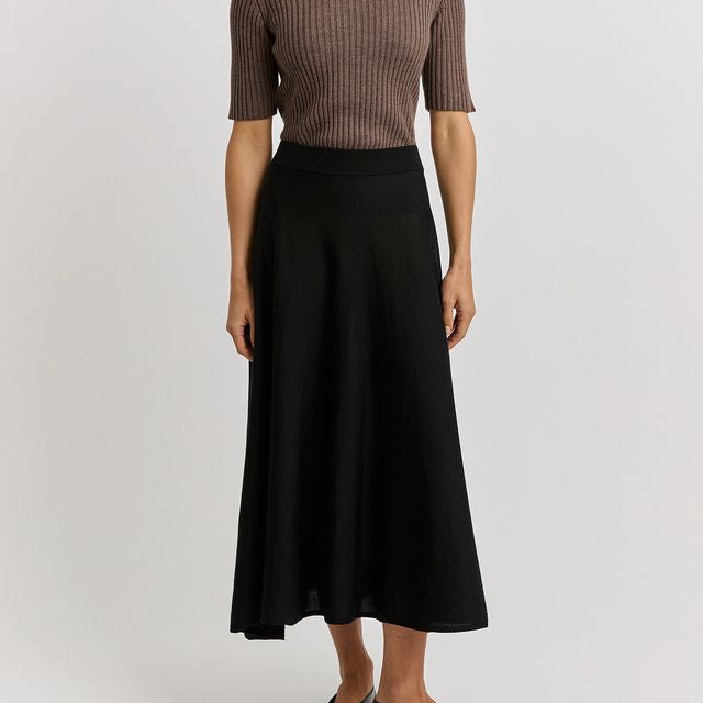 Woman wearing the Merino wool A-Line Knit Skirt in black by toorallie