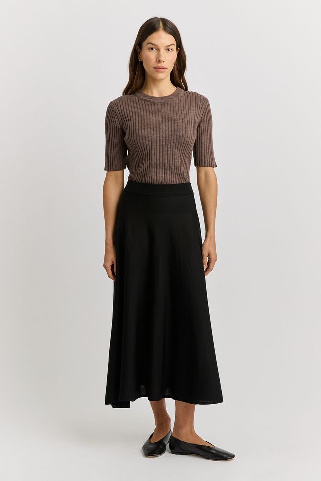 Woman wearing the Merino wool A-Line Knit Skirt in black by toorallie