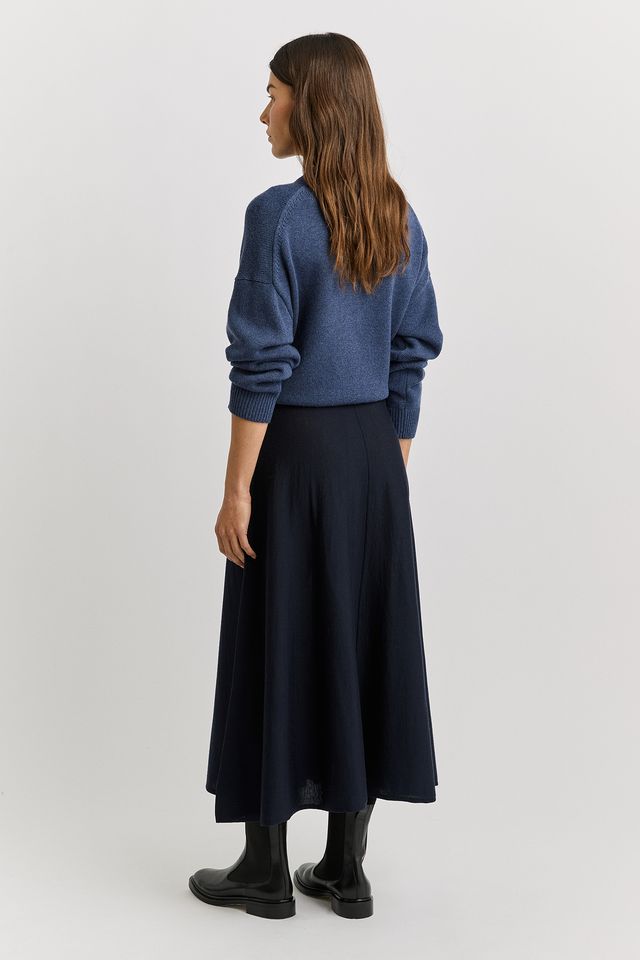 Woman wearing the A-Line Knit Merino Skirt in French navy by Toorallie