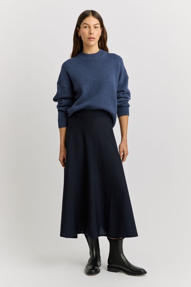 Woman wearing the A-Line Knit Merino Skirt in French navy by Toorallie
