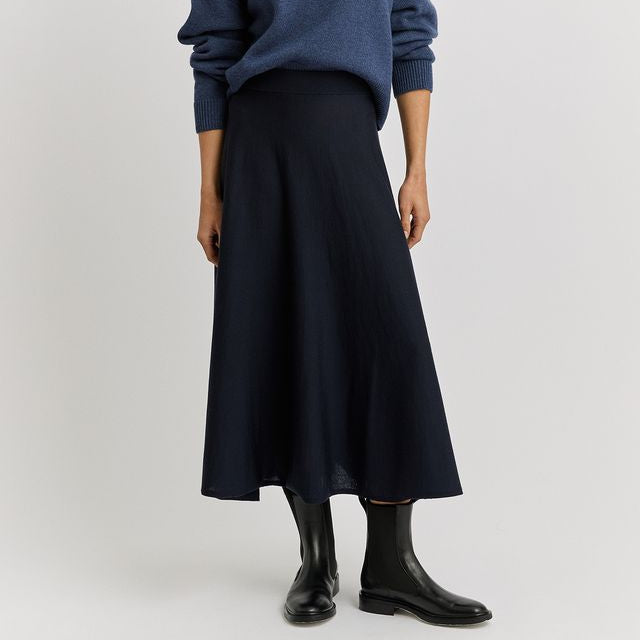 Woman wearing the A-Line Knit Merino Skirt in French navy by Toorallie