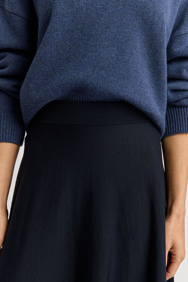 Woman wearing the A-Line Knit Merino Skirt in French navy by Toorallie