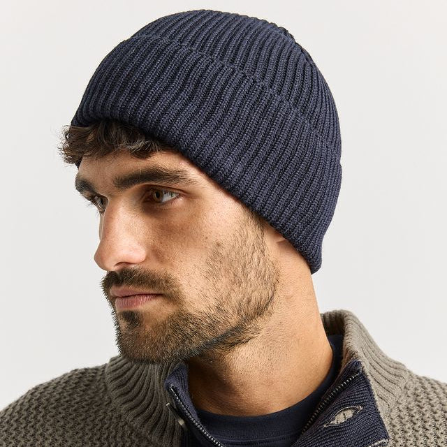 Man wearing the French Navy Merino Rib Beanie by Toorallie