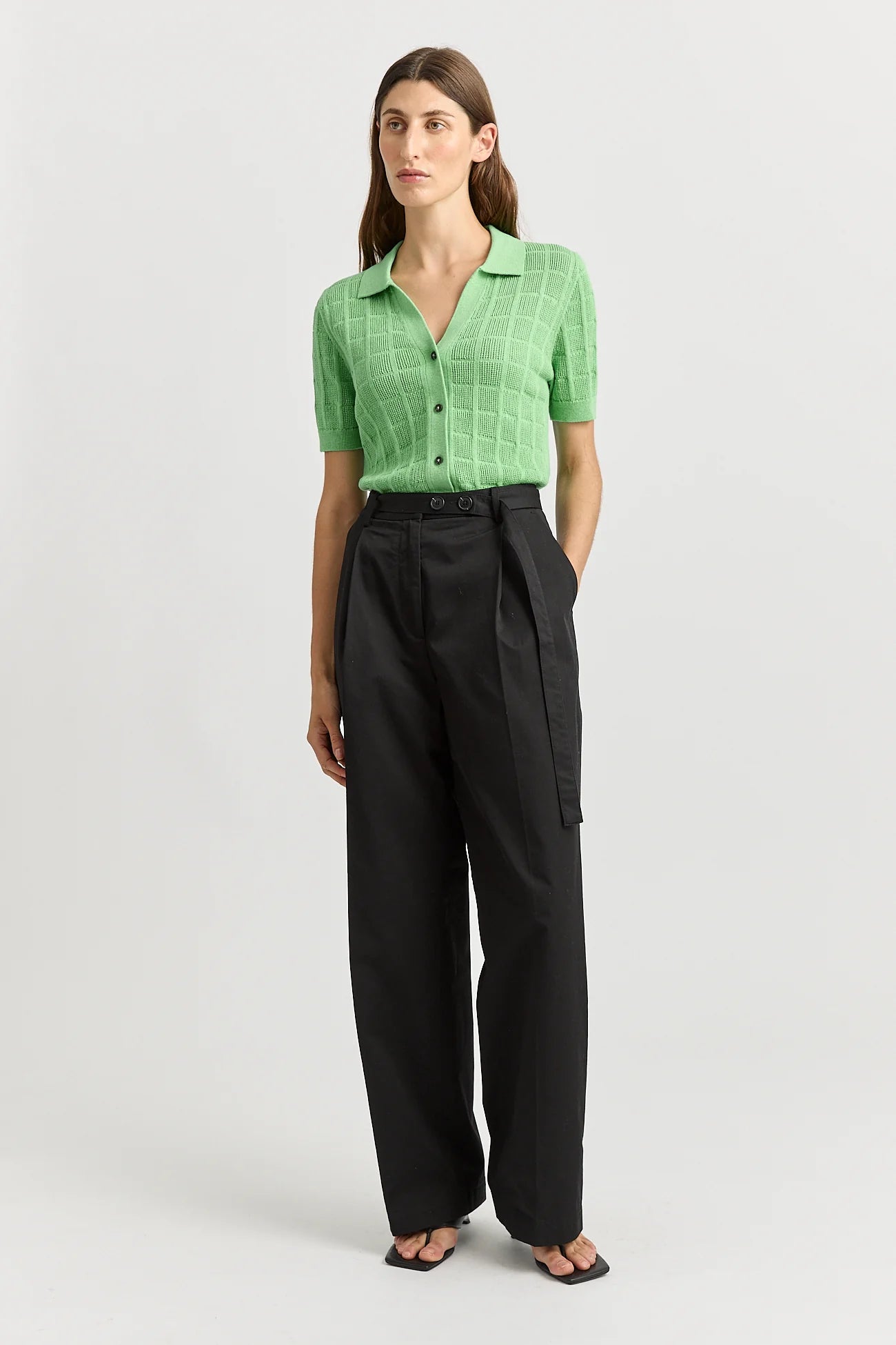 Woman wearing Toorallie's Open Stitch merino cotton knit top in Agave green