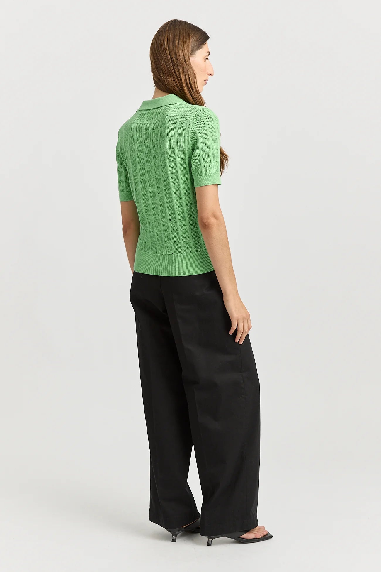 Woman wearing Toorallie's Open Stitch merino cotton knit top in Agave green