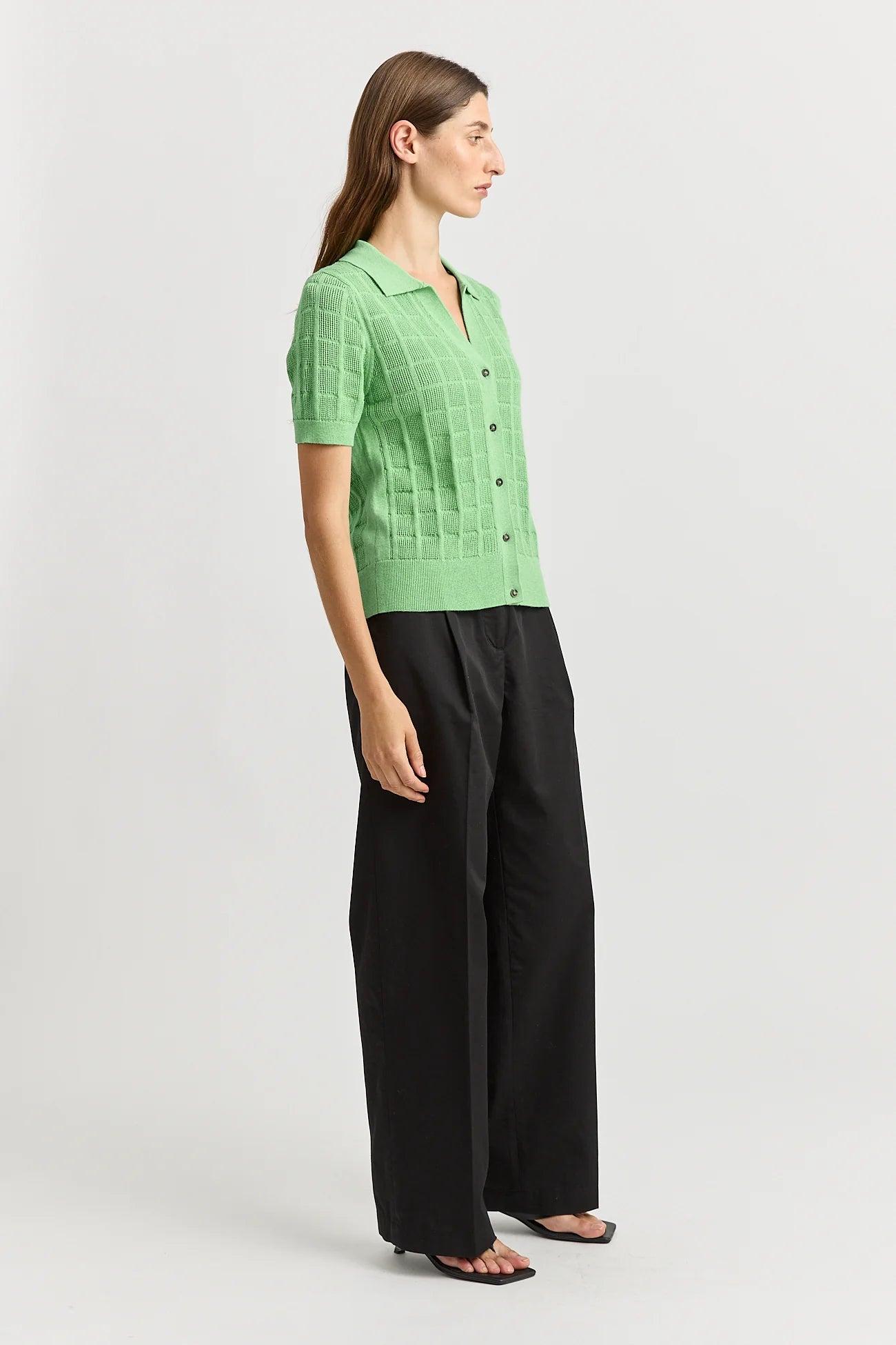 Woman wearing Toorallie's Open Stitch merino cotton knit top in Agave green