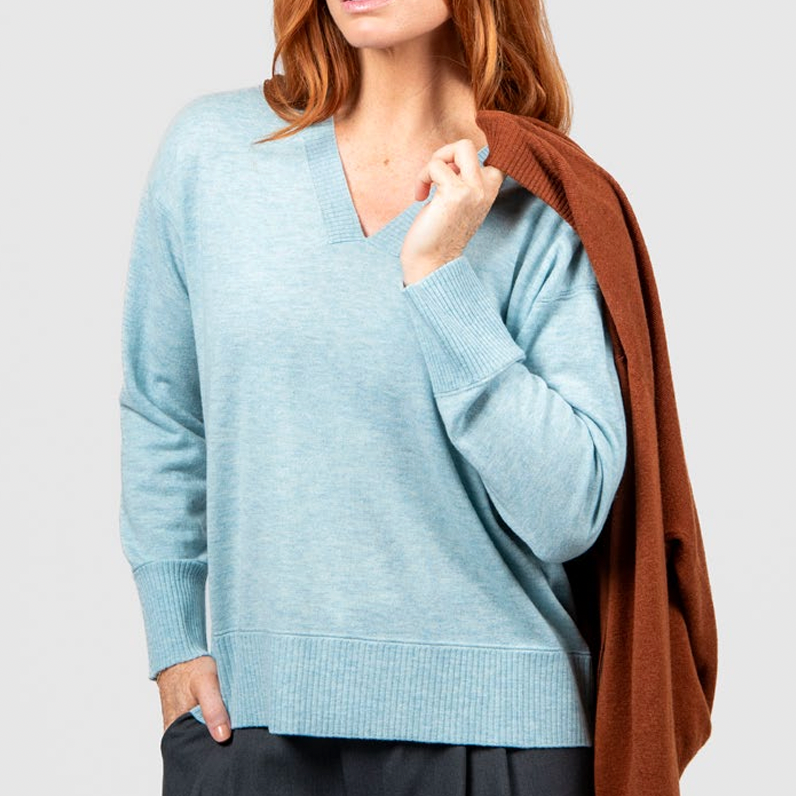 Woman wearing the Vee Neck Pullover with Trim in Aquamarine blue from Bridge and Lord
