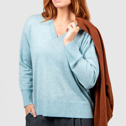 Woman wearing the Vee Neck Pullover with Trim in Aquamarine blue from Bridge and Lord