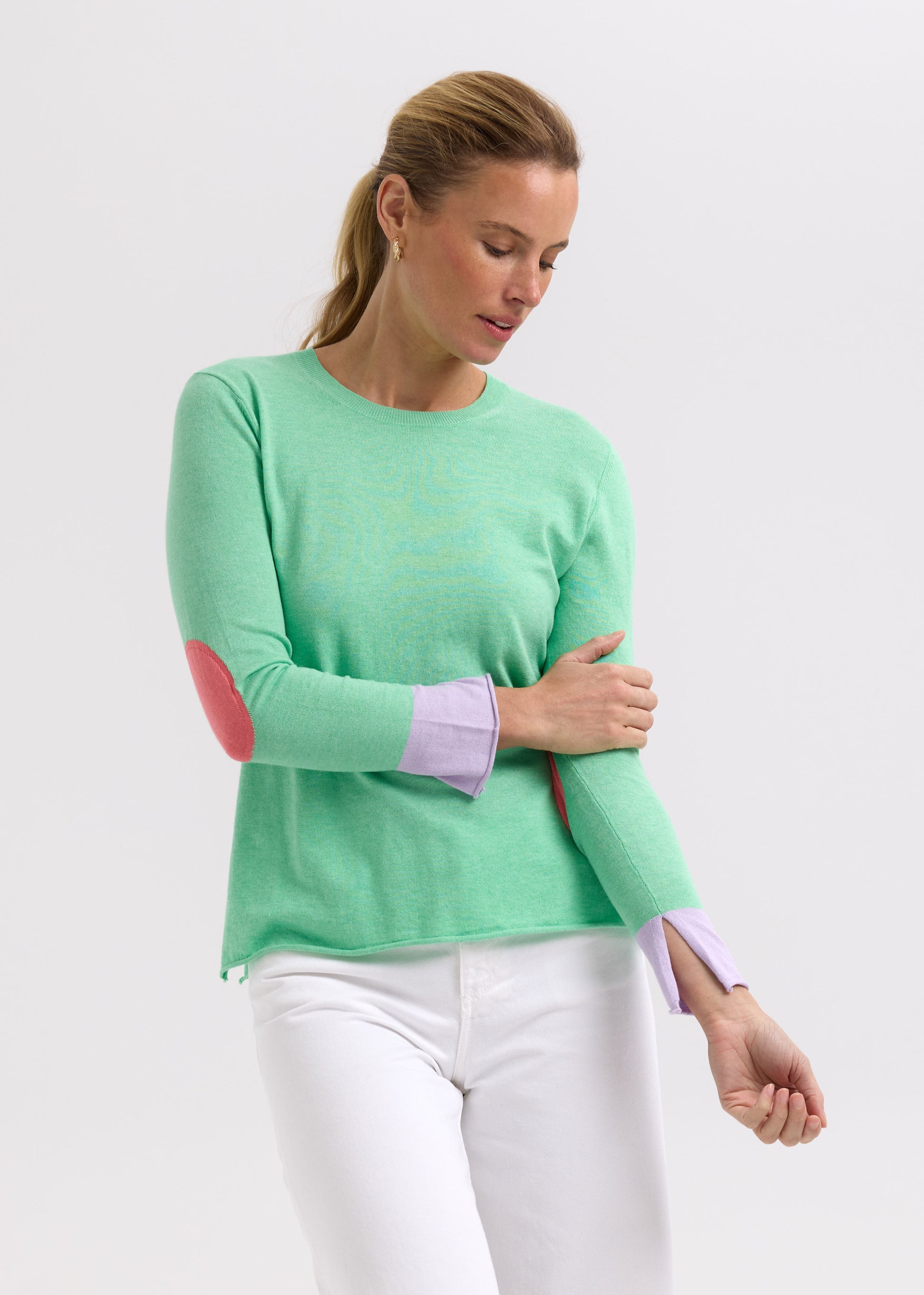Woman wearing the Elbow Patch Jumper by Zaket and Plover in Spearmint green
