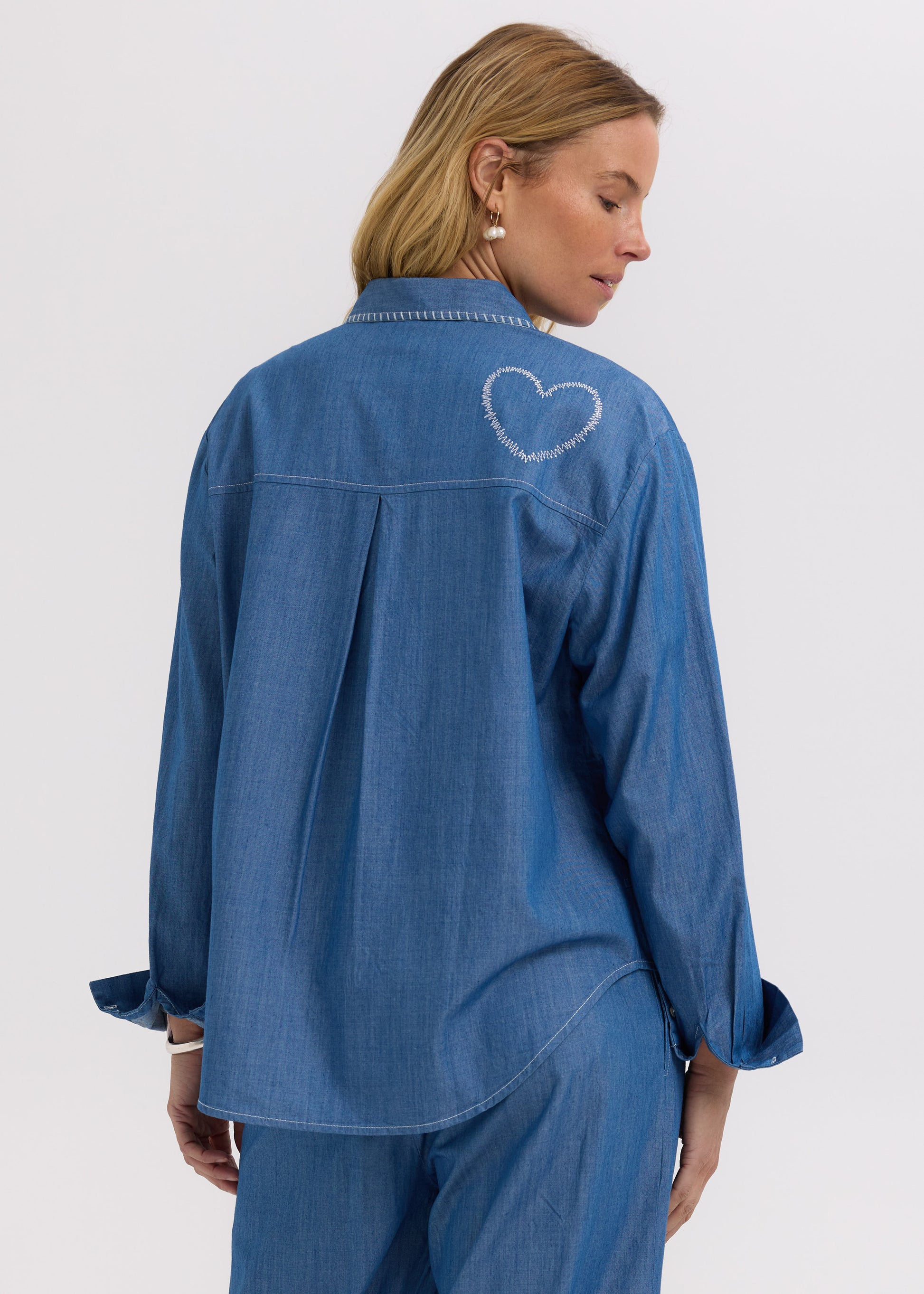 Woman wearing the Hand Work embroidered Denim Shirt by Zaket and Plover