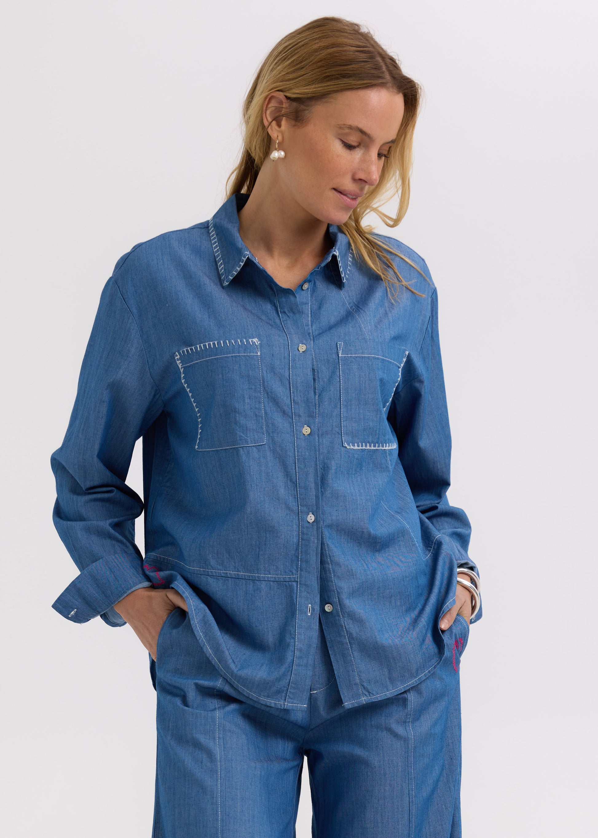 Woman wearing the Hand Work embroidered Denim Shirt by Zaket and Plover