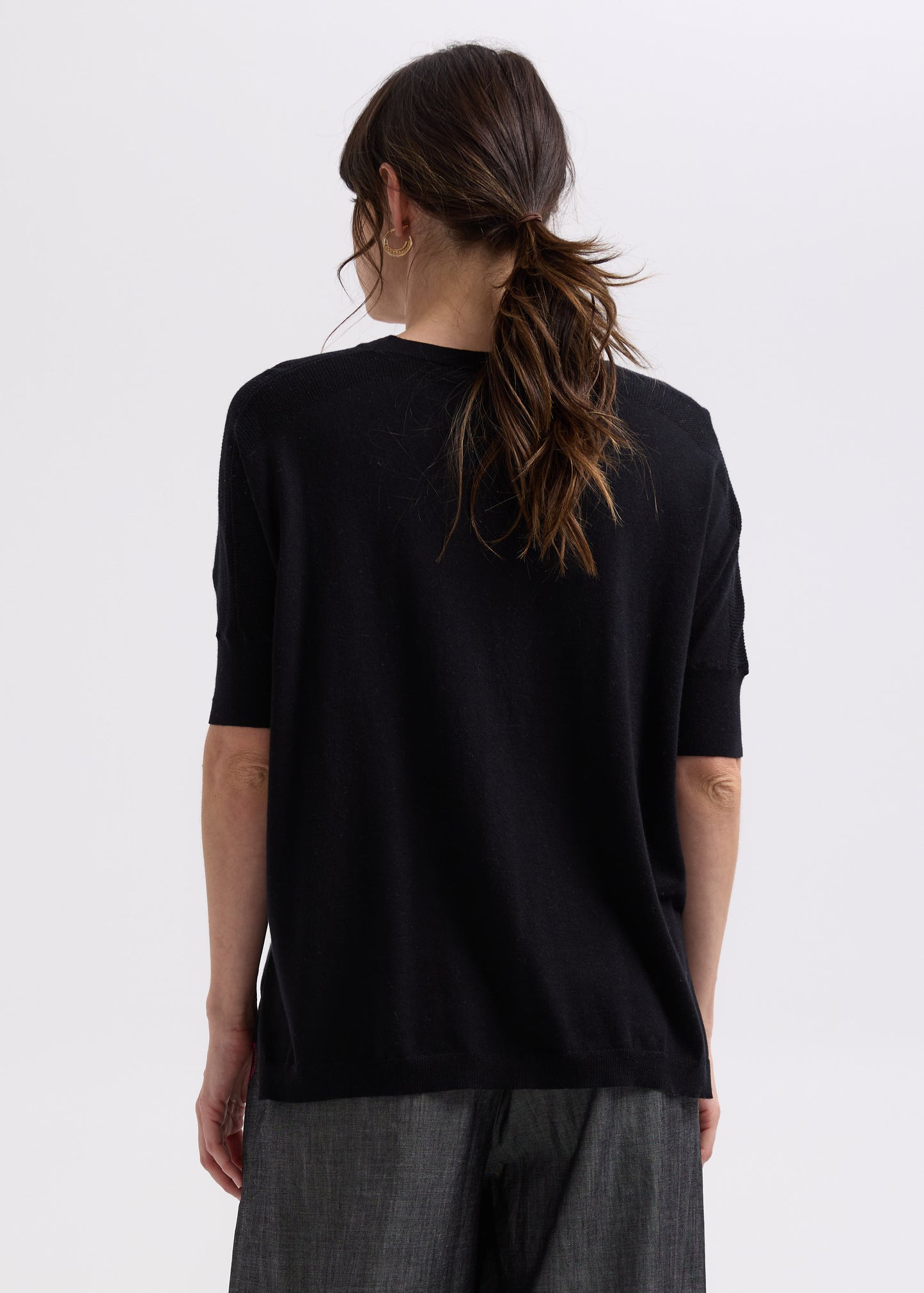 Woman wearing the Pointelle Shoulder Top by Zaket and Plover in black