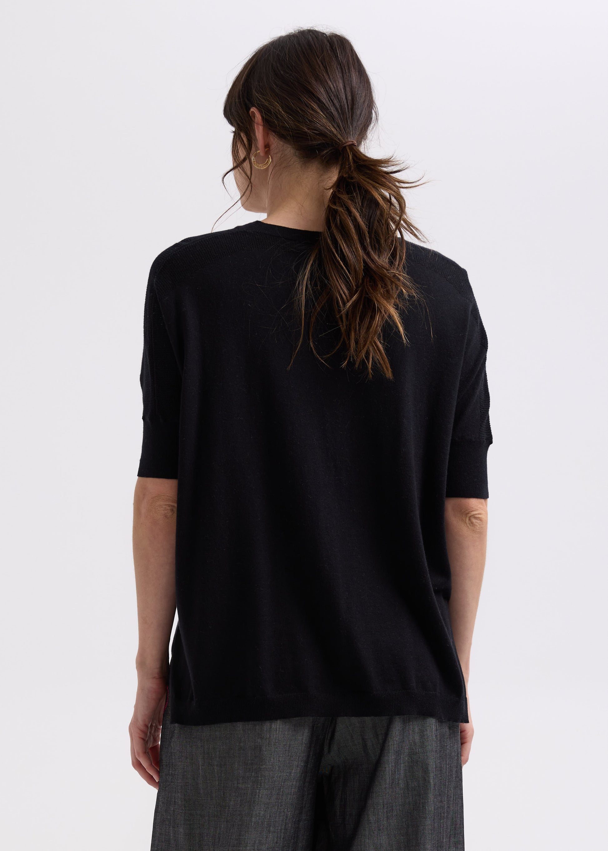 Woman wearing the Pointelle Shoulder Top by Zaket and Plover in black