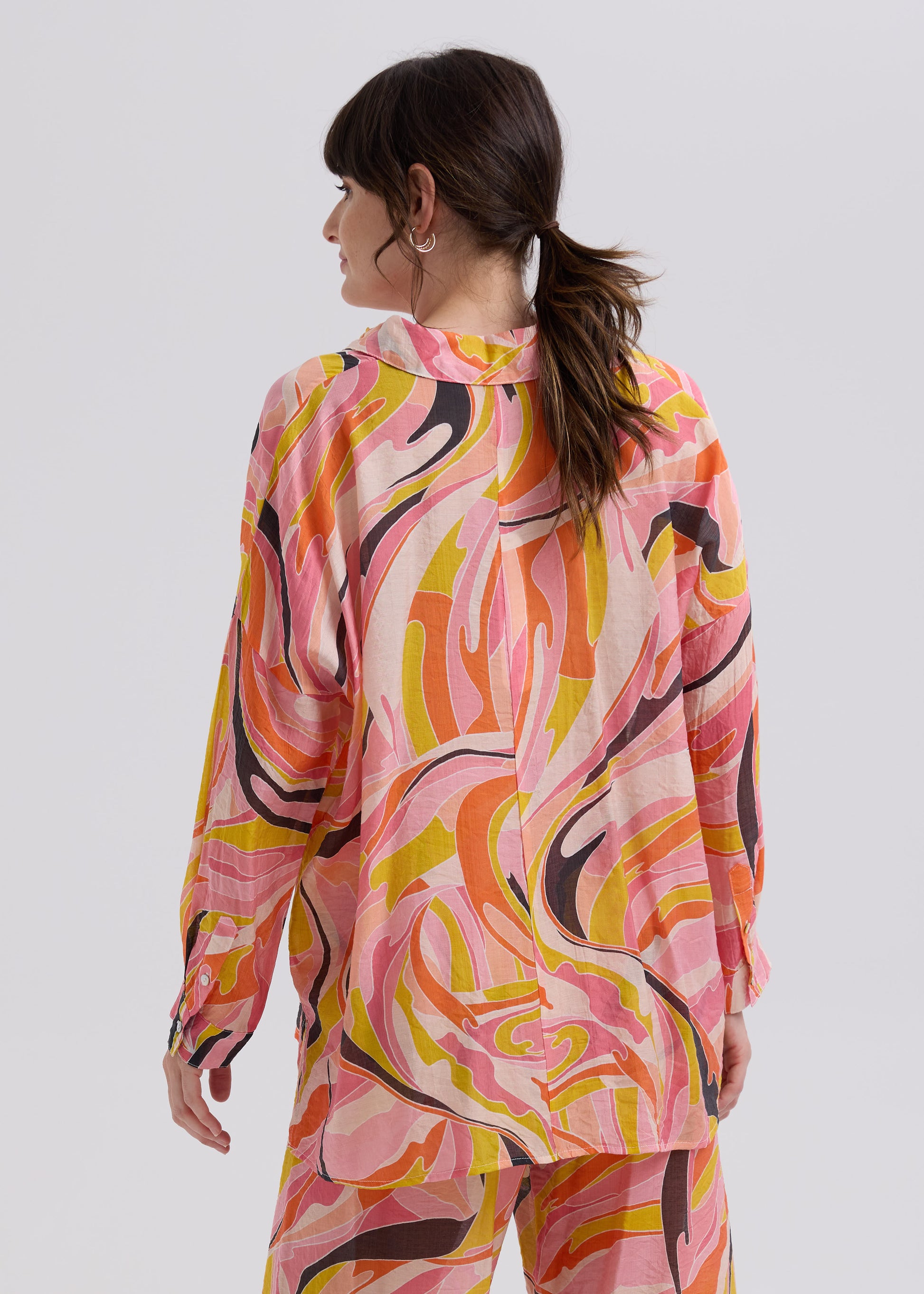 Woman wearing the Summer Shirt with matching set Summer Pants by Zaket and Plover in Sunset orange