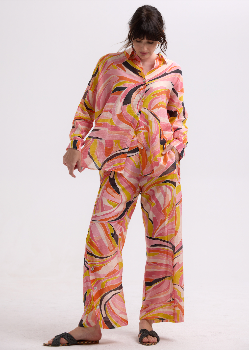 Woman wearing the Summer Shirt with matching Summer Pants by Zaket and Plover in Sunset orange