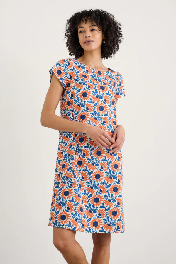 Woman wearing the River Cove Shift cotton Dress by SEASALT in Sunflower print
