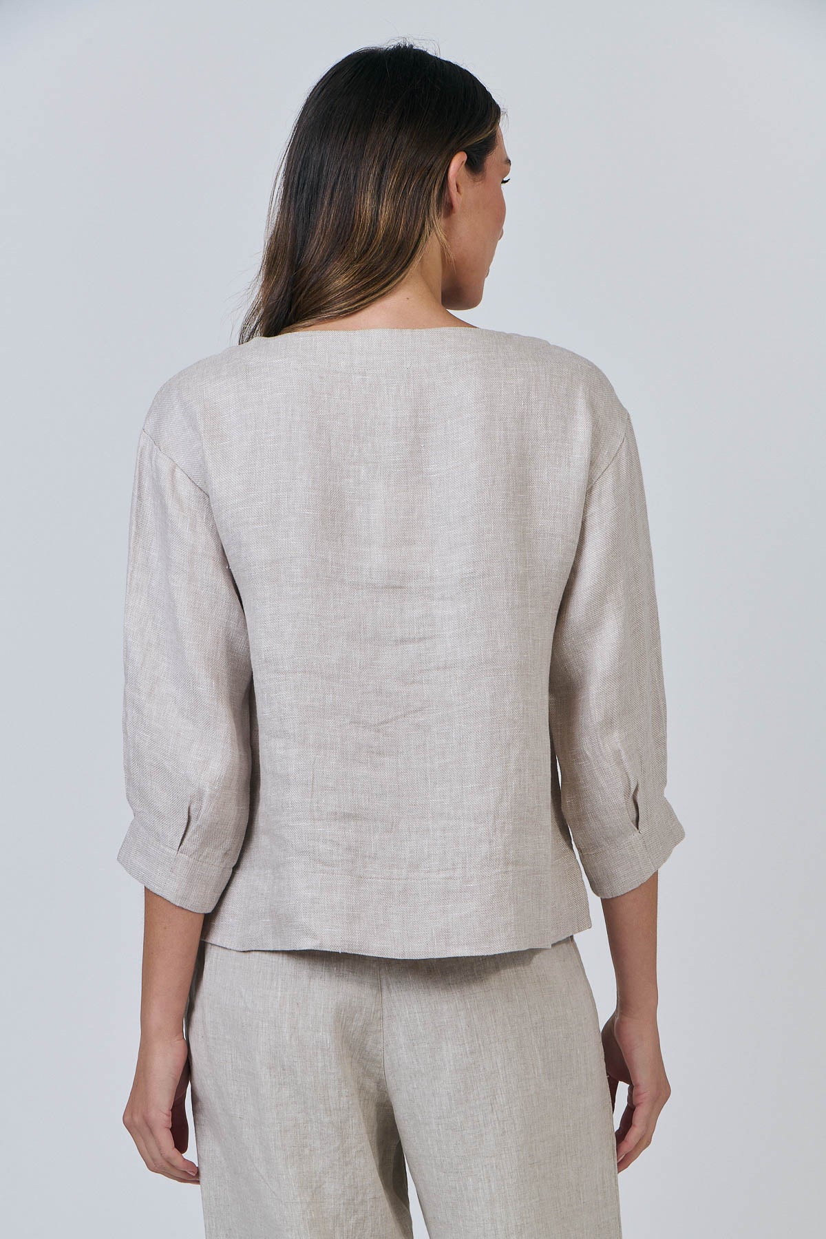 Woman wearing the linen round neck top by Naturals by OJ in Dune beige