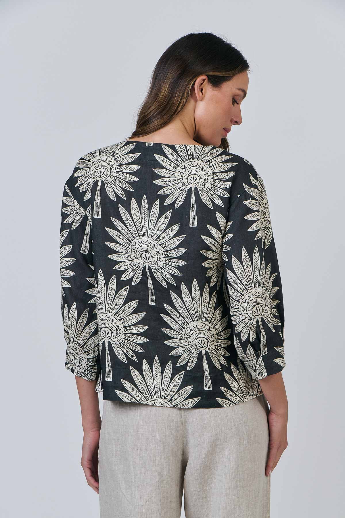 Woman wearing the round neck top by Naturals by OJ in date palm
