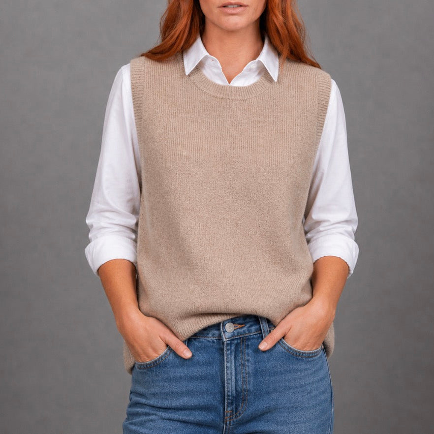 Woman wearing the crew neck brown vest by Bridge and Lord in Cobblestone