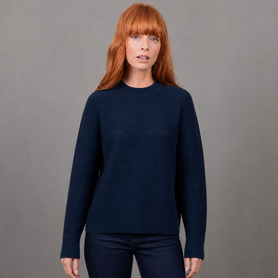 Woman wearing the Bridge and Lord Dolman sleeve navy jumper