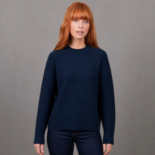 Woman wearing the Bridge and Lord Dolman sleeve navy jumper