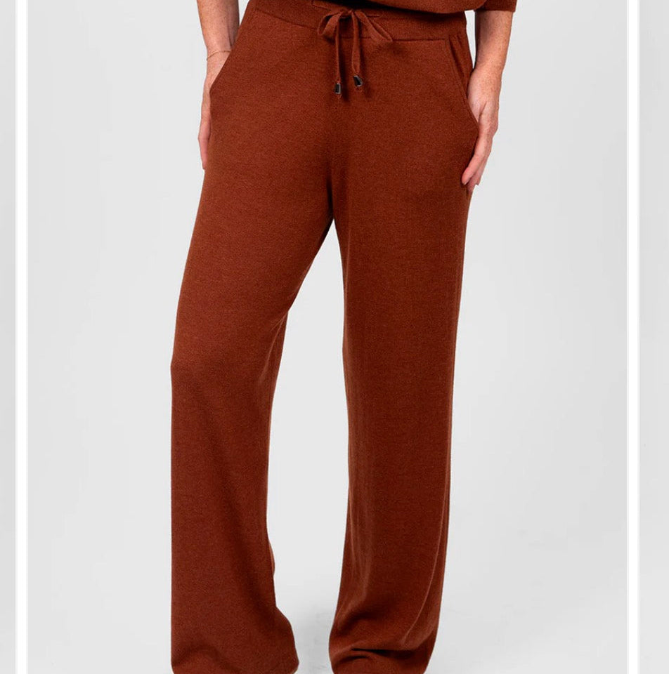 Woman wearing the Bridge and Lord relaxed wide leg pants in cognac brown