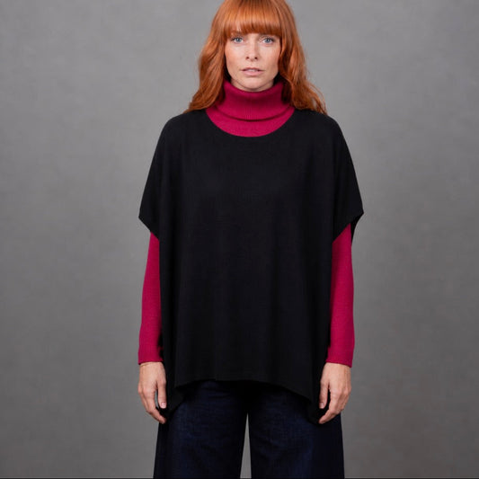 Woman wearing the Bridge and Lord seed stitch black poncho