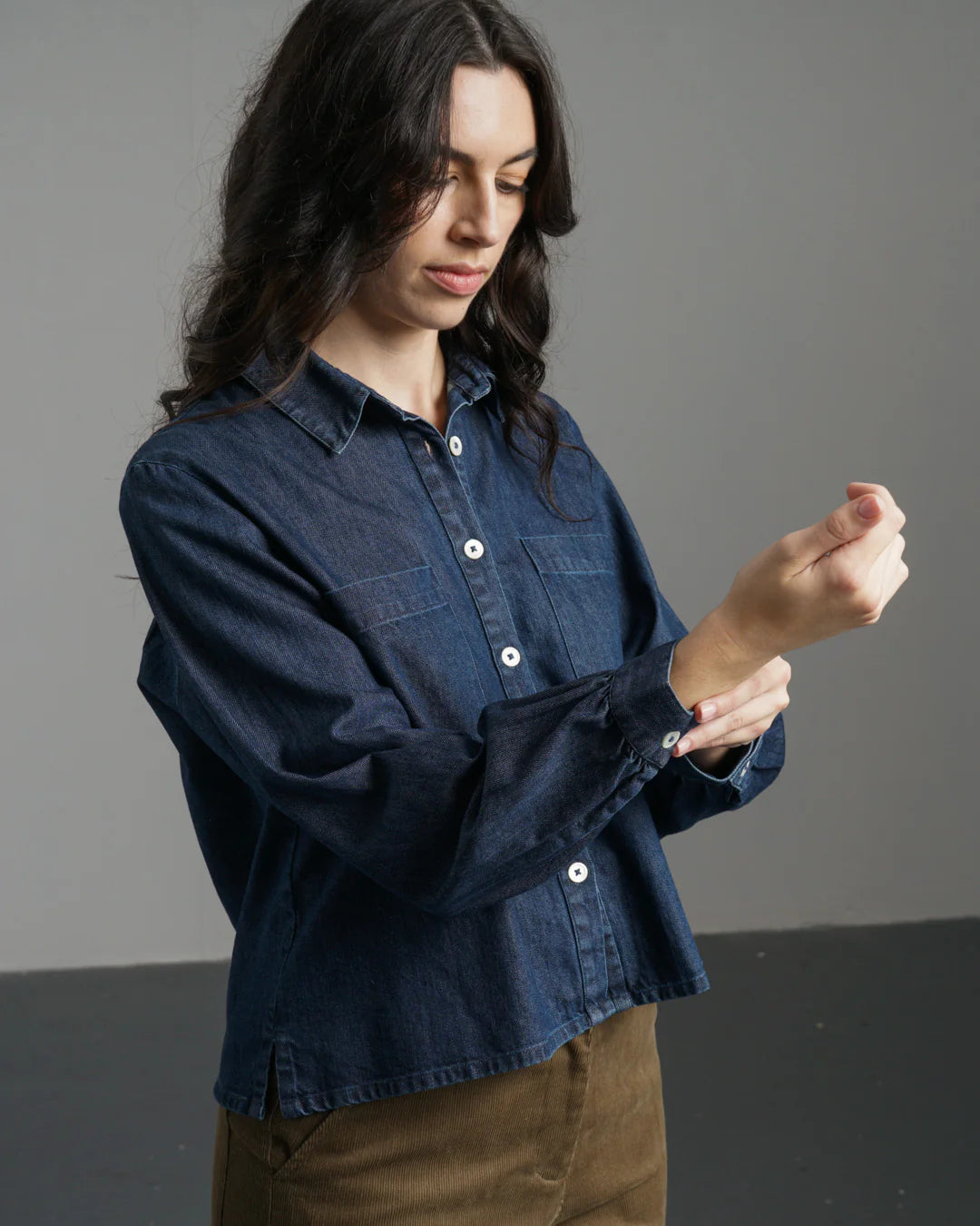 Woman wearing the Bibico Ada denim shirt made with buttons and a collar