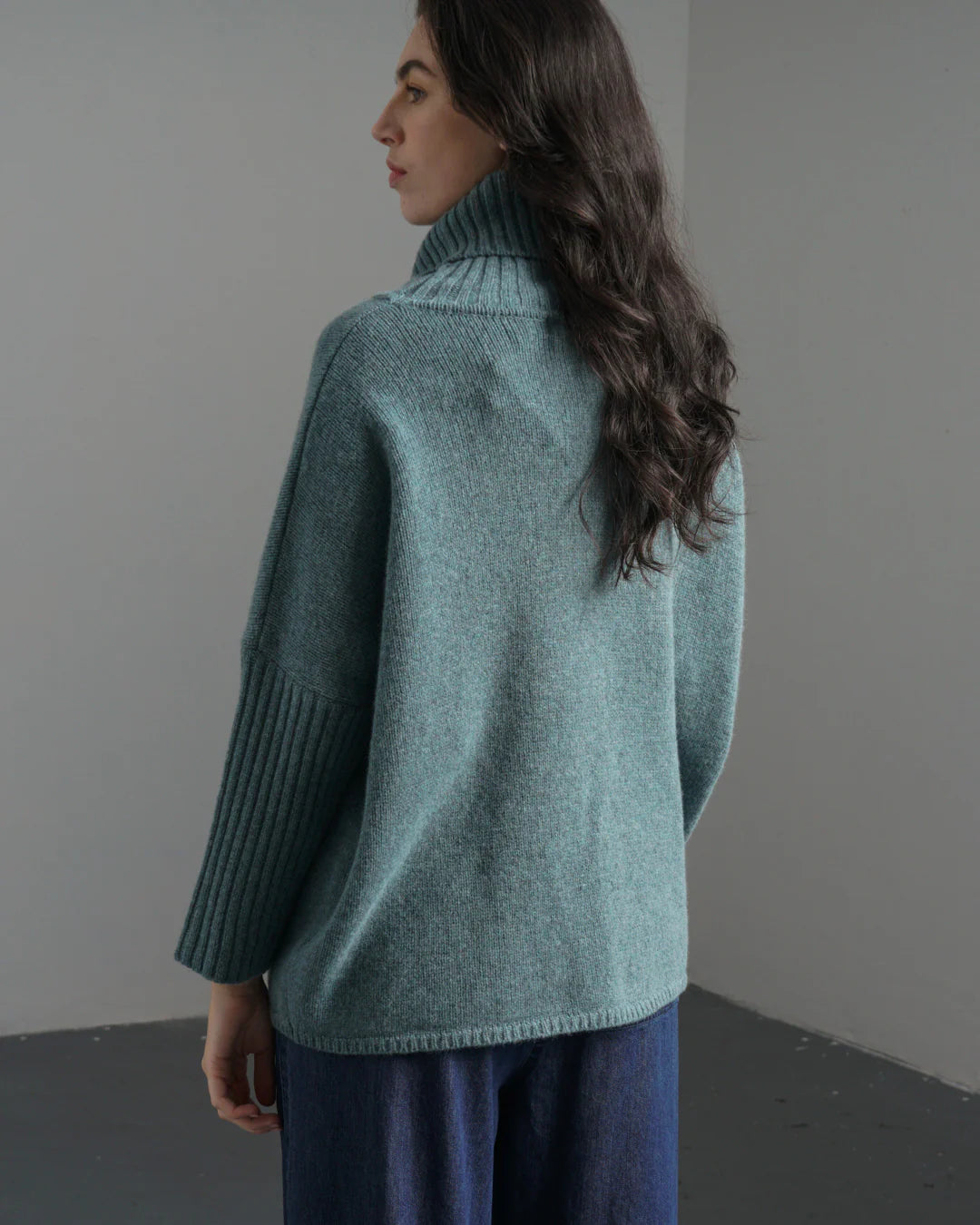 Woman wearing the Bibico Adela turtleneck sweater in Caspian blue