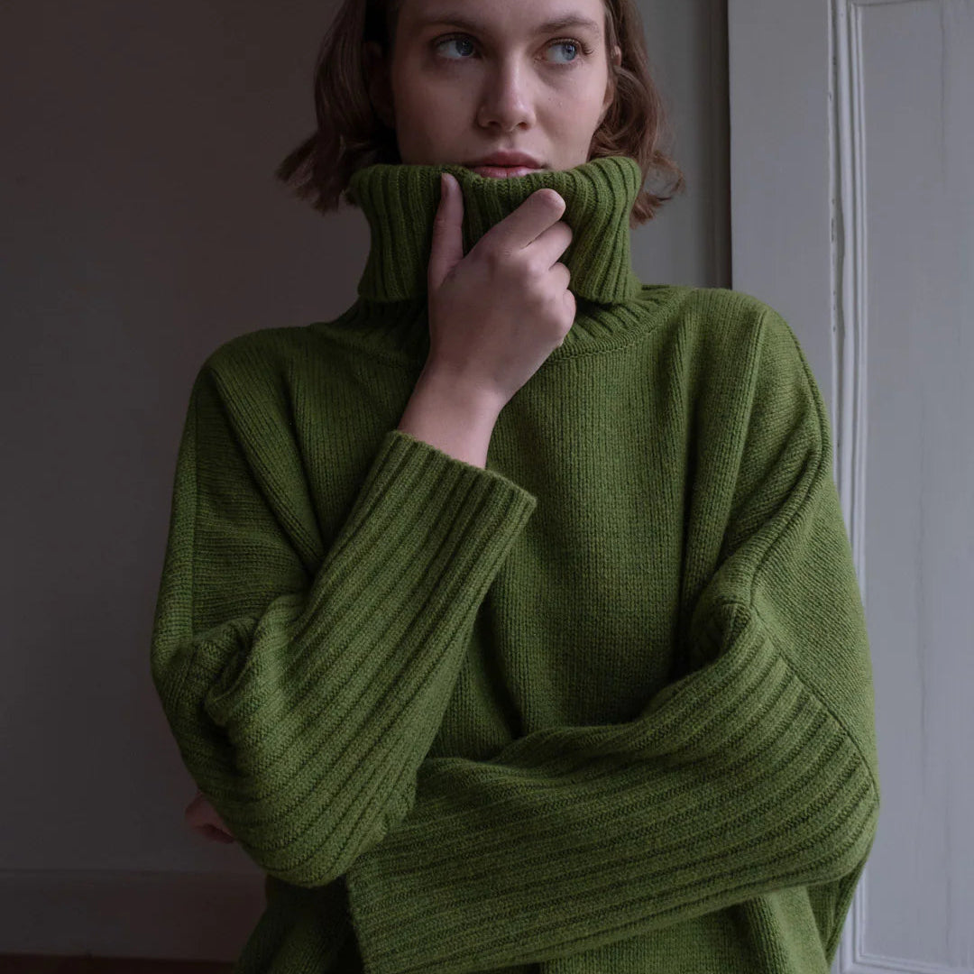Woman wearing the Bibico Adela woollen turtleneck Jumper in Moss green