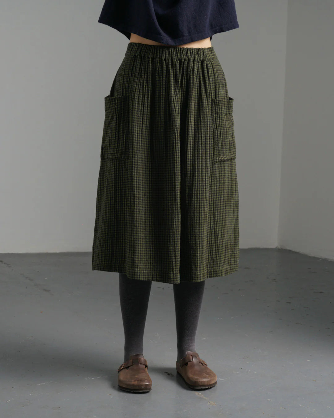 Woman wearing the Bibico Nora cotton winter Skirt in plaid olive green