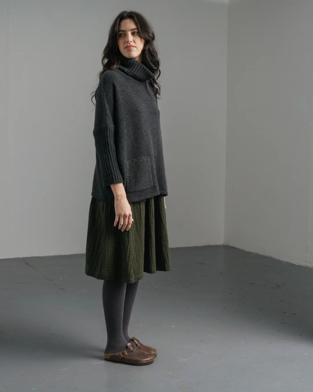 Woman wearing the Bibico midi Nora Skirt in checked olive green