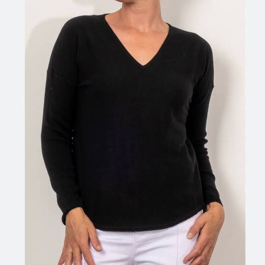 Woman wearing a Black vee neck top by bridge and lord