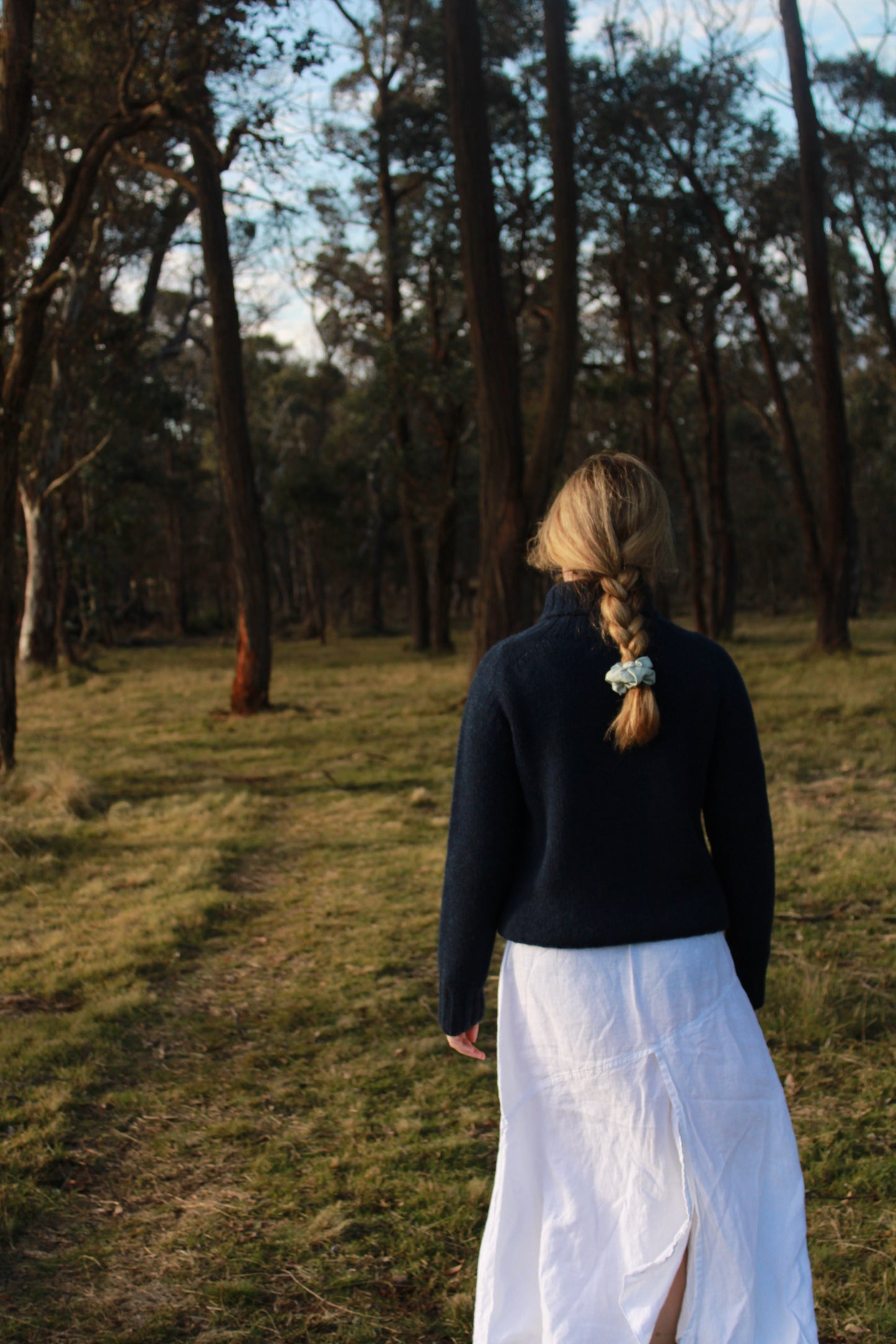 Harley's Chunky Lambswool jumper in navy, woman walking in park