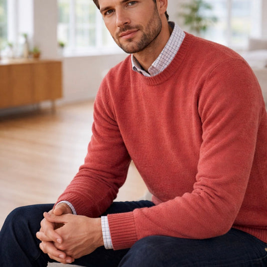 Man wearing  a quality merino wool jumper in dusty red.