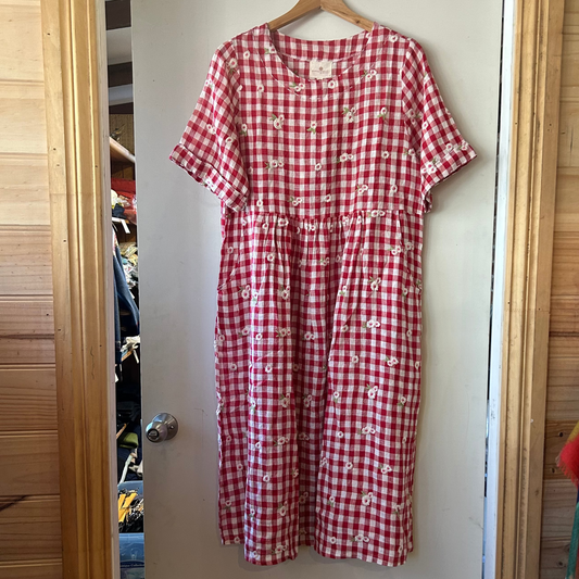Red gingham dress with embroidered flowers from Mnadalay Designs.