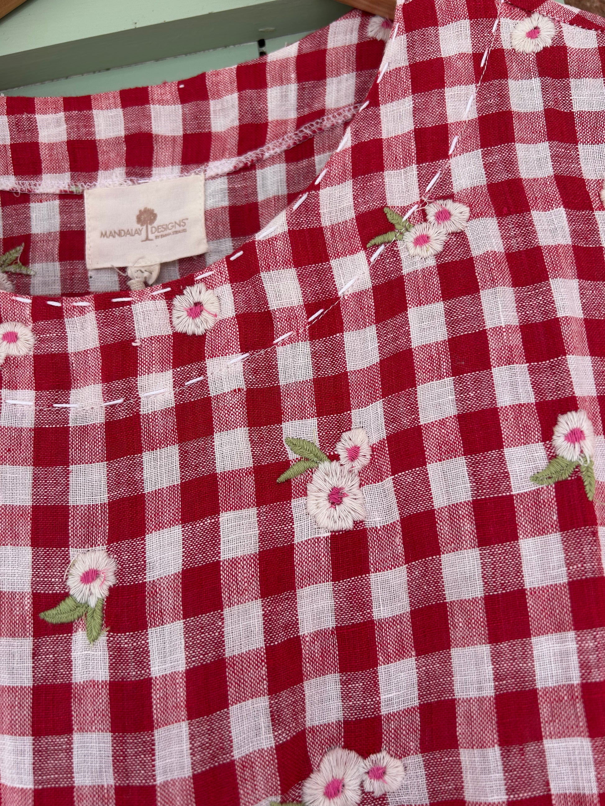 Detail of stitching  on neck of Mandalay Designs gingham dress.