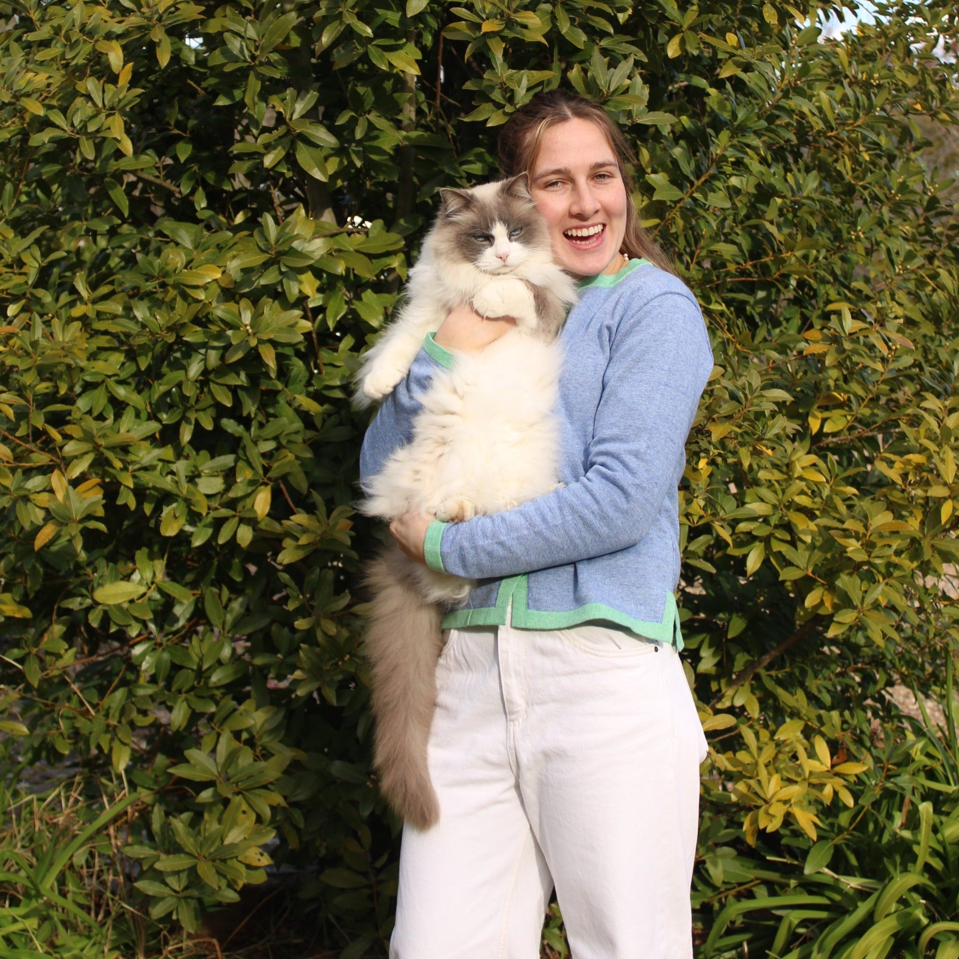 NoK's Noa Cardigan in Light Blue, woman wearing cardigan with cat