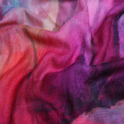 Close-up of colorful fabric with pink, purple, and red hues.