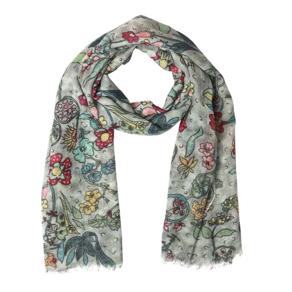 Colorful floral and bird patterned scarf on a white background