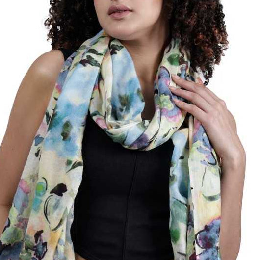 Woman wearing a merino wool and silk colorful scarf with a floral pattern