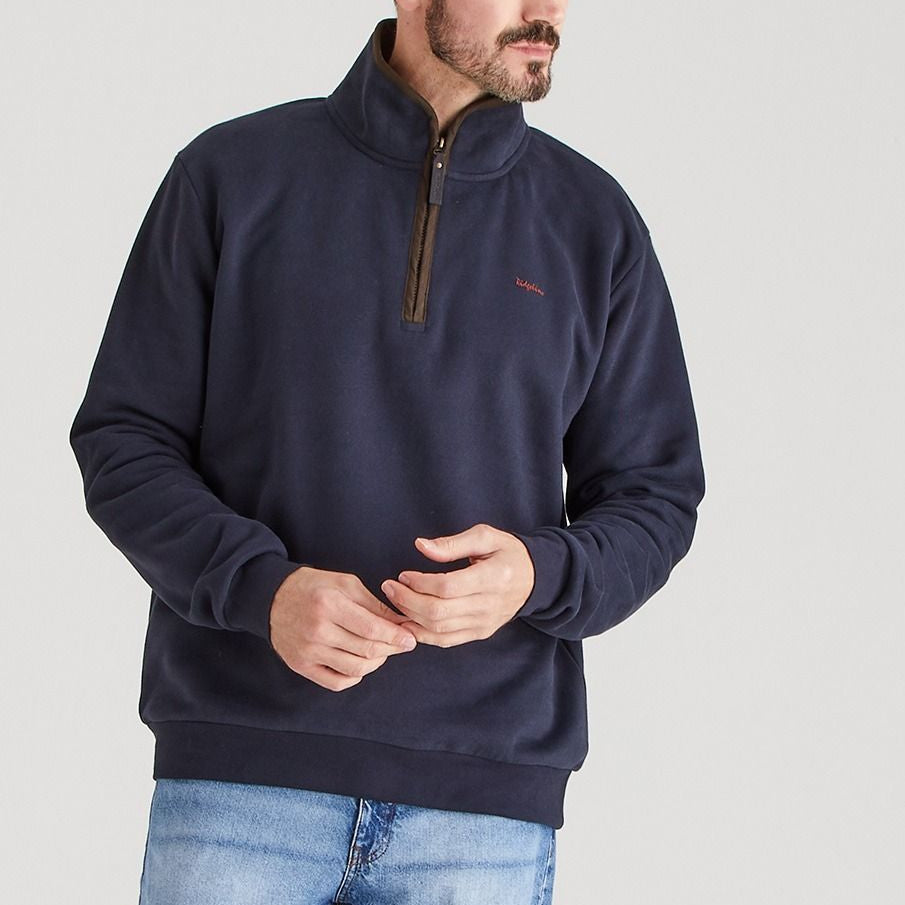 Man wearing a navy blue pullovera from Ridgline quality outdoor clothing,.