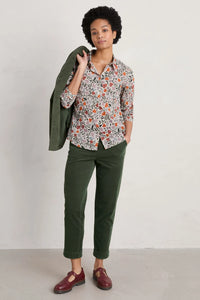 SEASALT's Larissa Shirt in Folklore Bloom Aran, styled with green trousers and blazer and mary janes