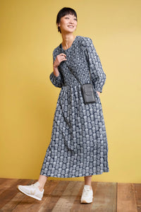 SEASALT's Meadowsweet maxi dress in lace stems maritime colourway, styled with crossbody bag and sneakers
