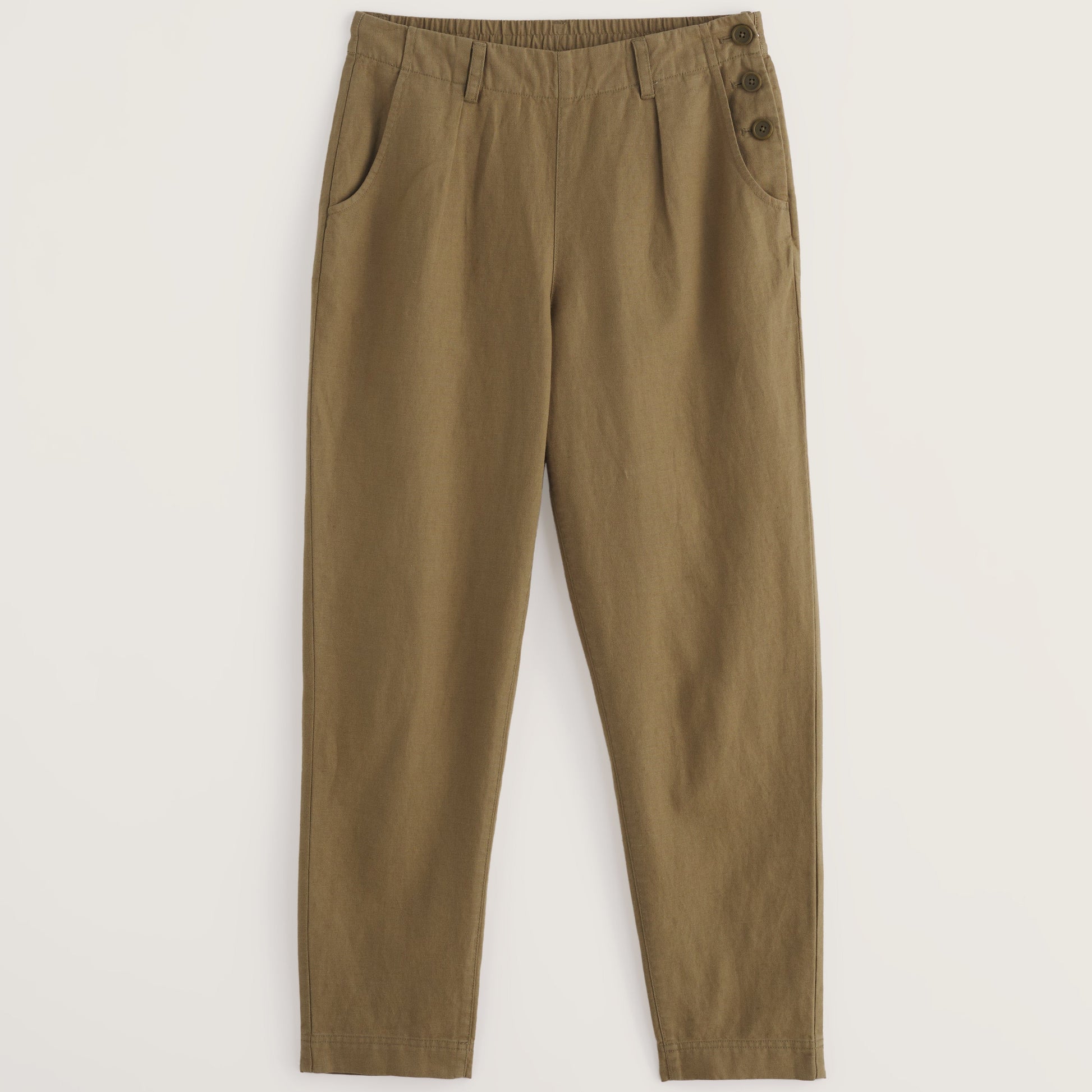 Seasalt Brown pants with button details on a light beige background